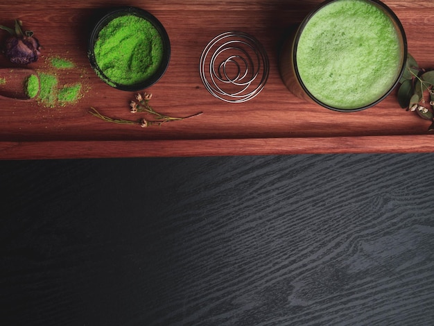 Matcha latte and matcha green tea on red wooden surface