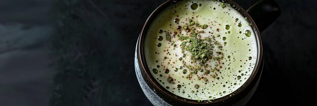 Matcha latte with cacao on top over black background