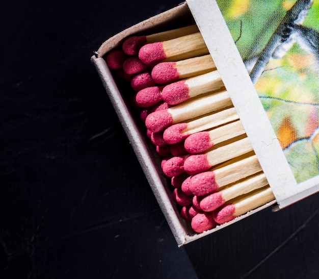 Matchbox with matches on the wooden background with copy space