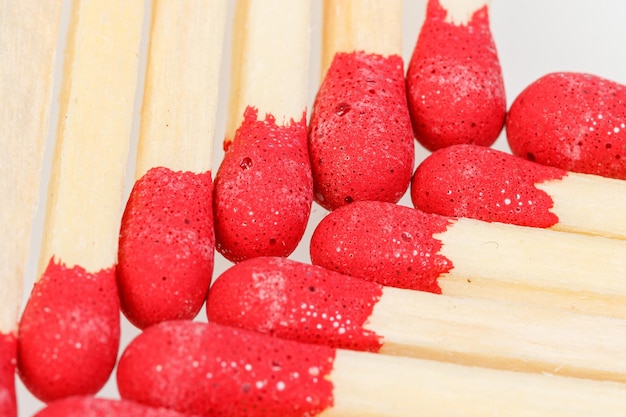 Matches with a red head on a white background