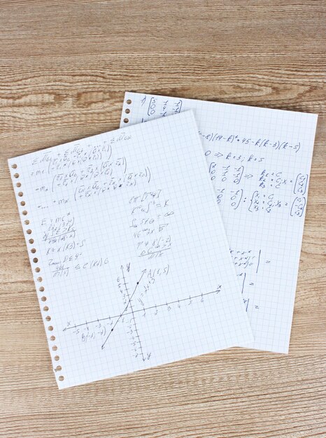 Photo math physics and geometry on copybook page on a wooden table