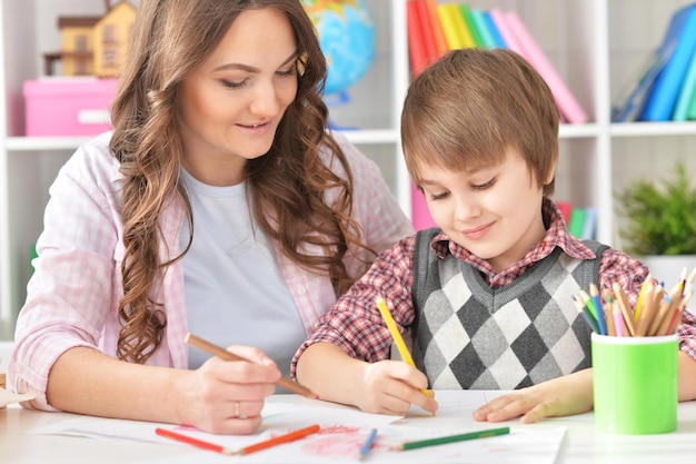 Mather and her little son drawing with colorful pencils