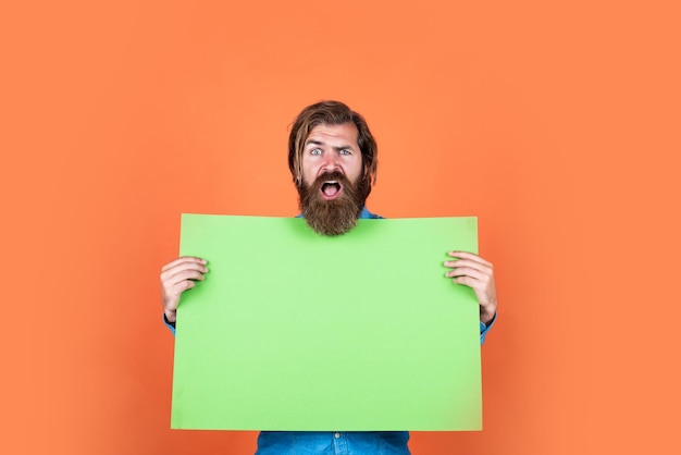 Mature bearded guy has long hair hold paper placate copy space idea