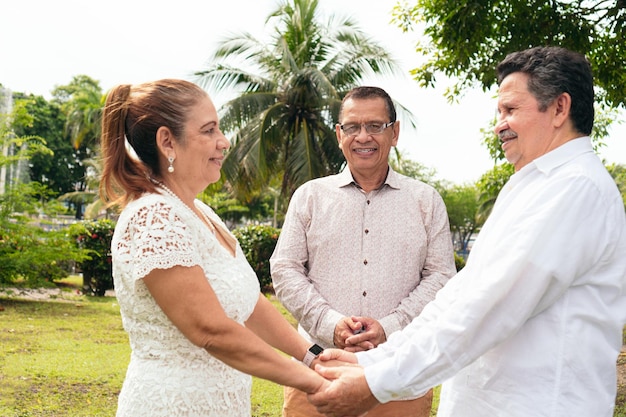 Mature bride and groom holding hands at a wedding