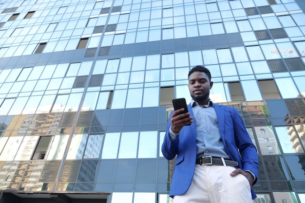 Mature businessman enjoys working ceo against office building