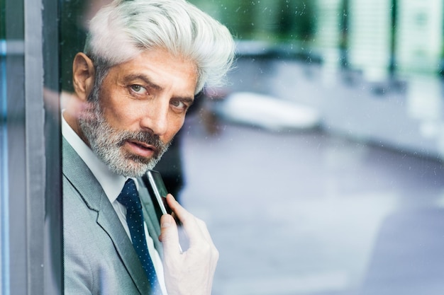 Mature businessman in the office looking out