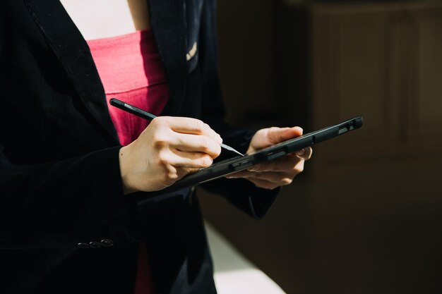 Mature businessman using a digital tablet to discuss information with a younger colleague in a moder