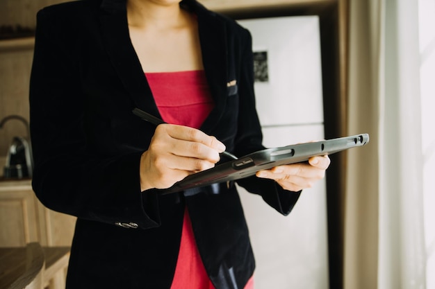 Mature businessman using a digital tablet to discuss information with a younger colleague in a moder