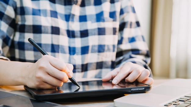 Mature businessman using a digital tablet to discuss information with a younger colleague