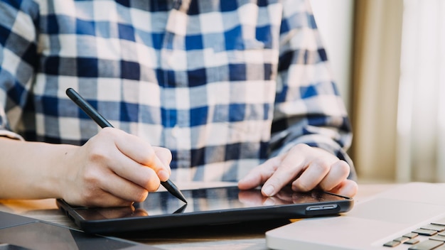 Mature businessman using a digital tablet to discuss information with a younger colleague