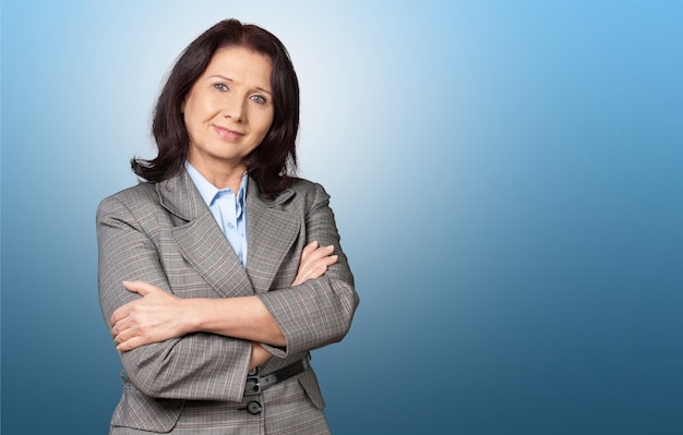 Mature businesswoman wearing formal suit on background