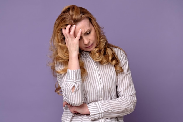 Mature caucasian woman mother or wife suffering a headache