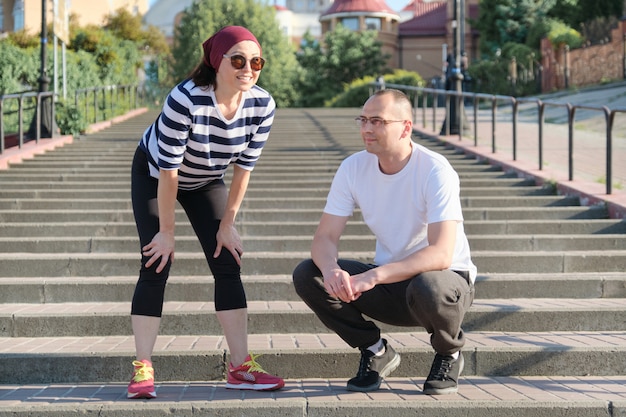 Mature couple in city near the stairs