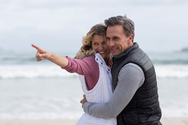 Mature couple embracing each other on the beach