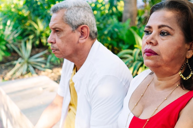 Mature couple sitting in the summer park