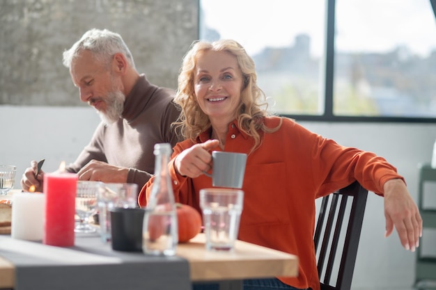 Mature couple sitting at the table and having dinner