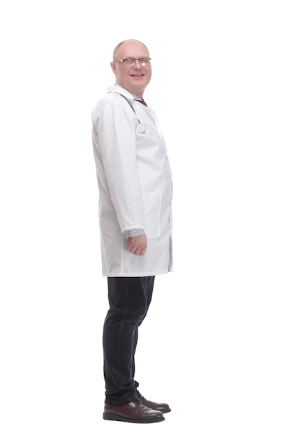 Mature doctor in a white coat striding forward