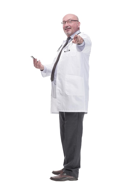 Mature doctor with smartphone isolated on a white background