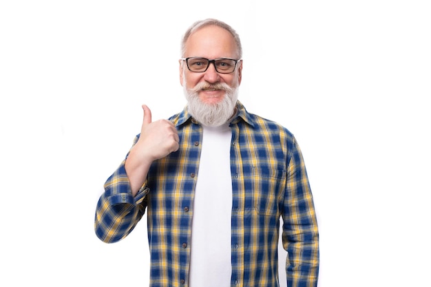 Mature grayhaired retired man with a mustache and beard shows a hand gesture for having an idea on a