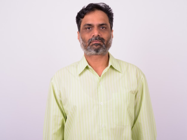 mature handsome bearded Indian businessman on white