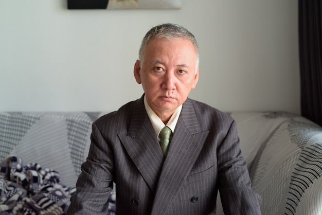 Mature Japanese businessman staying at home under quarantine