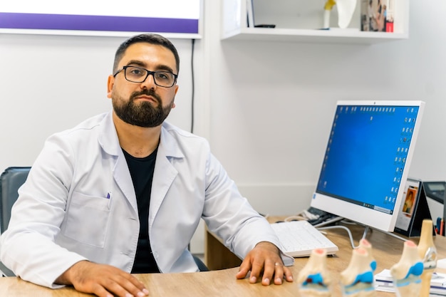 Mature male doctor looking at xray isolated on modern office backgound Healthcare people and medicine concept