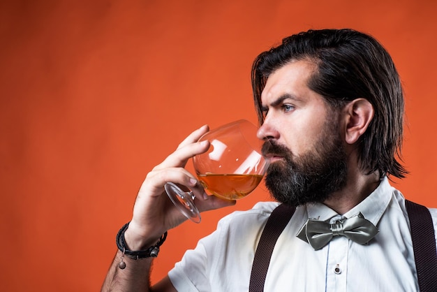 Mature man barman drinking hard alcohol beverage from glass bachelor