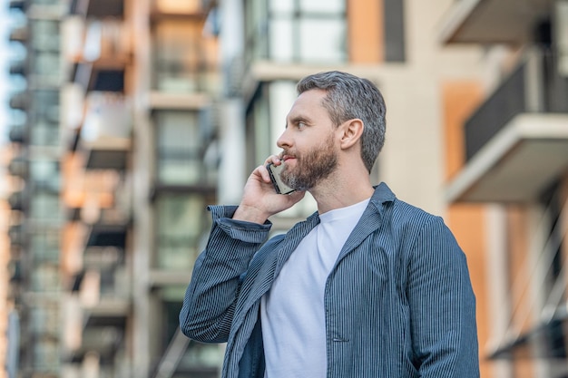 Mature man call on mobile outside photo of man call on mobile phone man has mobile call