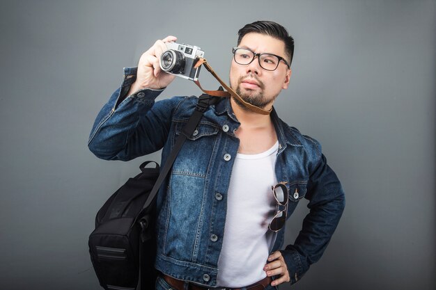 A mature man carries his schoolbag and equipment to travel.