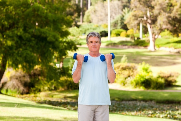 Mature man doing his exercises in the park