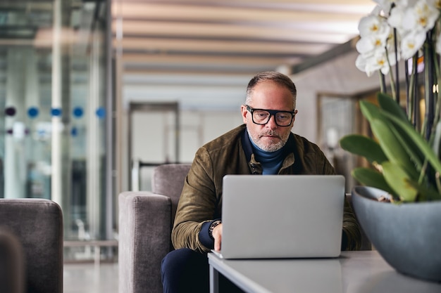 Mature man looking fixedly at his laptop