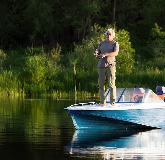 Mature man on a motor boat. Fishing