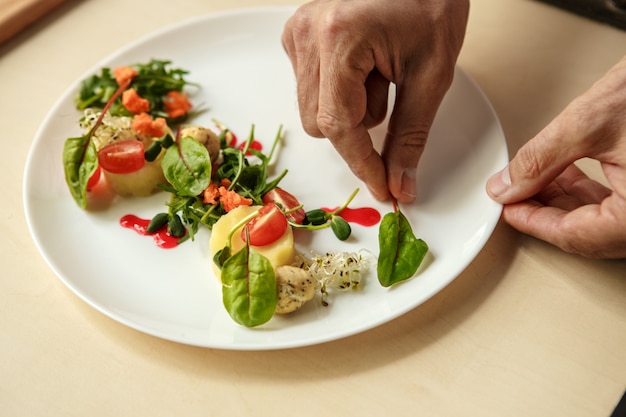 Mature man professional chef cooking meal indoors