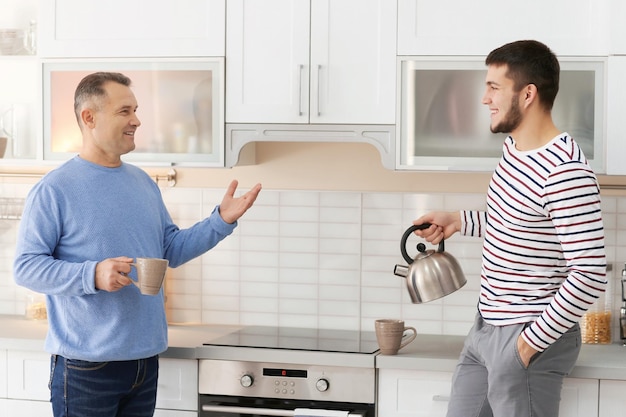 Mature man spending time with his son at home