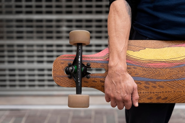 Mature man with sustainable mobility skateboard