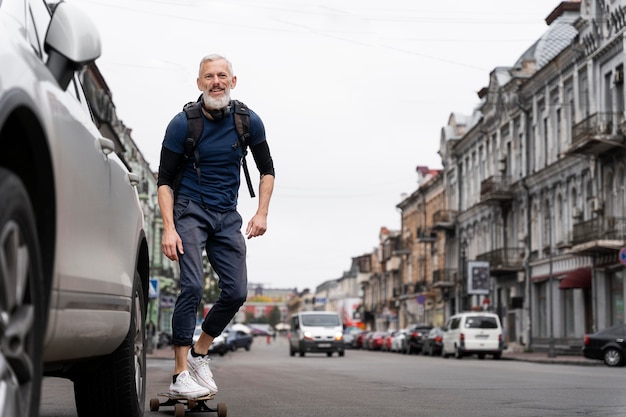 Mature man with sustainable mobility skateboard