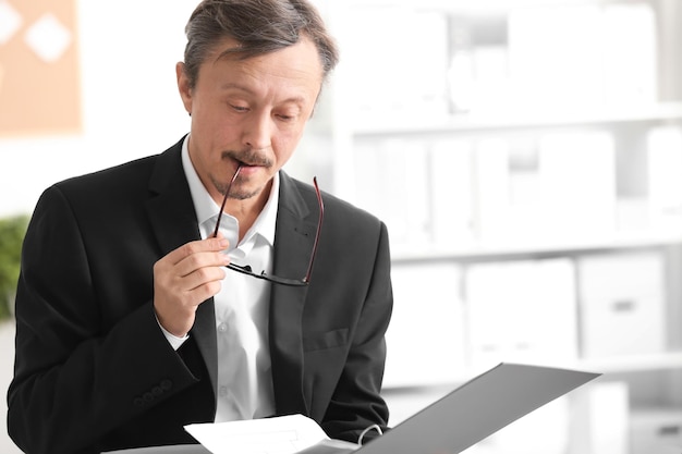 Mature man working with documents indoors