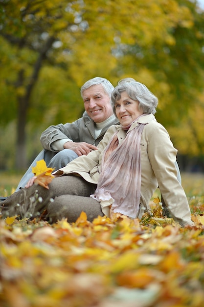 Mature married couple having fun on fresh air in autumn