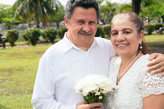 Mature newlywed couple embracing on their wedding day