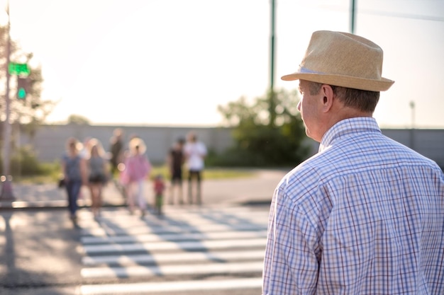 Mature spanish man waiting to cross street