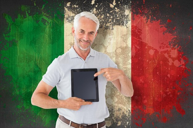 Photo mature student showing tablet pc against italy flag in grunge effect