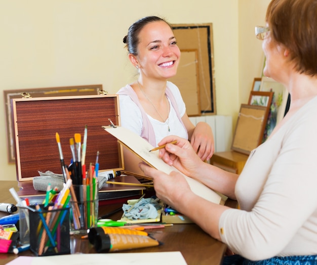 Mature woman paints a portrait