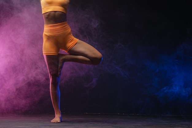 Mature woman practicing yoga on the floor Studio shoot