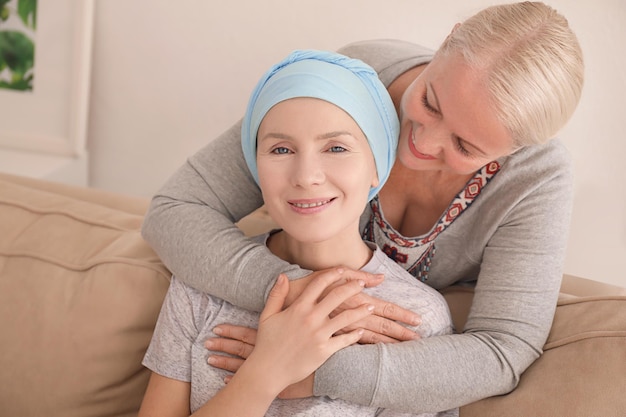 Mature woman visiting her daughter with cancer indoors