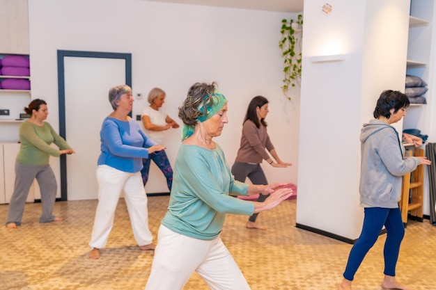 Mature women in a qi gong class choreographing the exercises