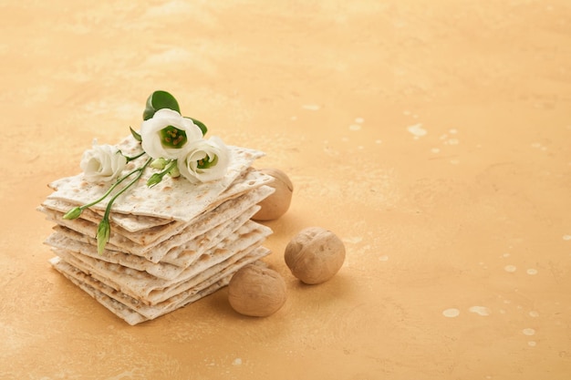 Matzah Passover celebration concept Traditional ritual Jewish bread on sand color old wall background Passover food Pesach Jewish holiday of Passover celebration concept Passover food