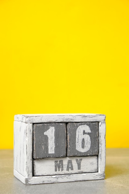 May 16 calendar made wooden cubes yellow backgroundWith an empty space for your text