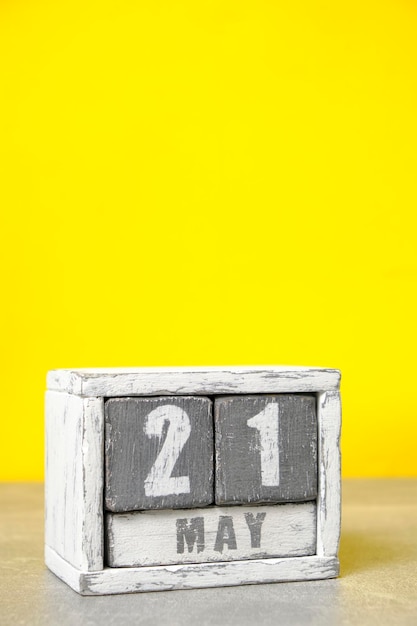 May 21 calendar made wooden cubes yellow backgroundWith an empty space for your text