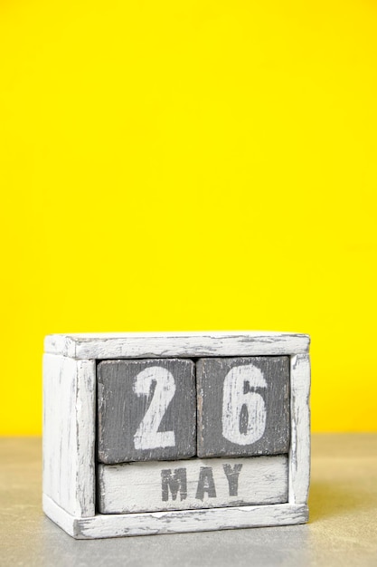 May 26 calendar made wooden cubes yellow backgroundWith an empty space for your text