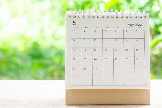 May month, Calendar desk 2022 for organizer to planning and reminder on wooden table with green nature background.